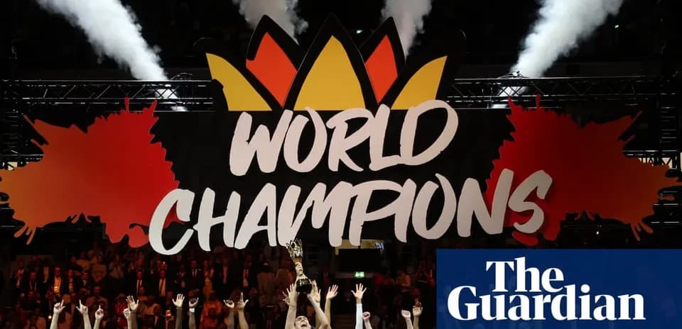 Team celebrating under 'WORLD CHAMPIONS' banner