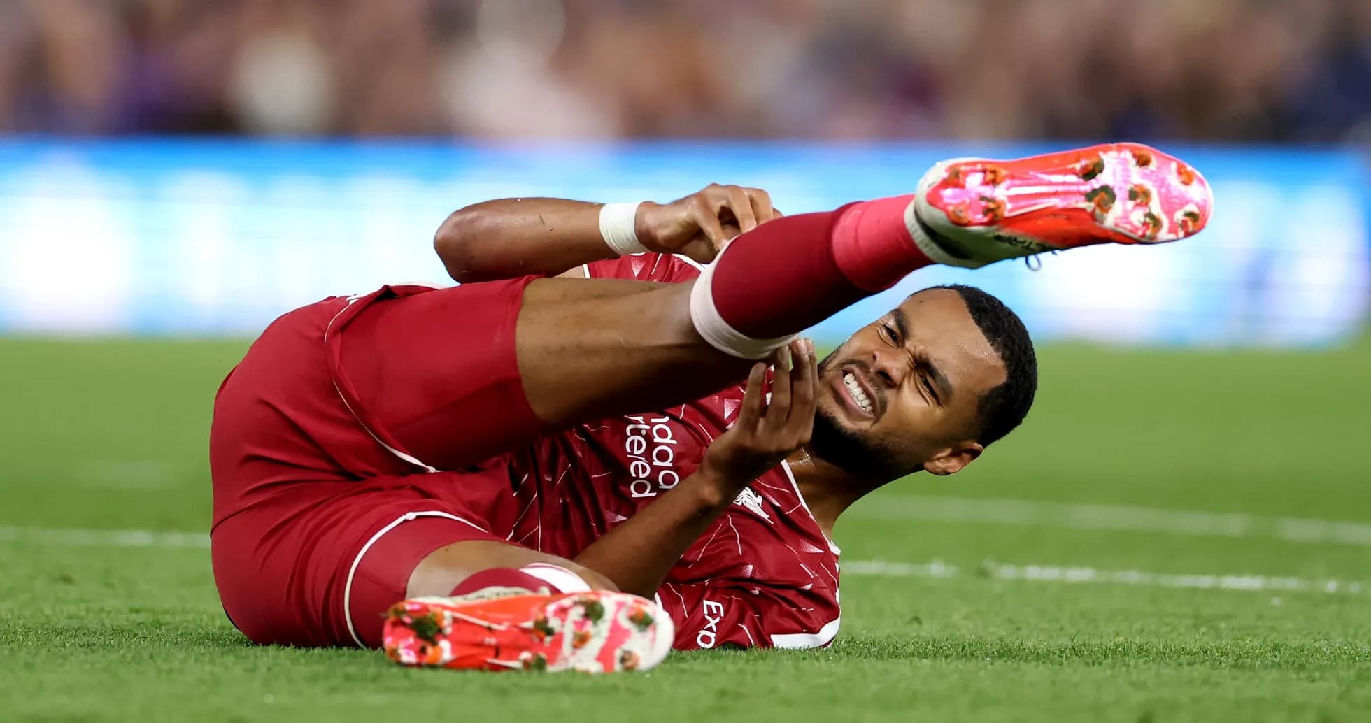 Player lying on field holding injured leg