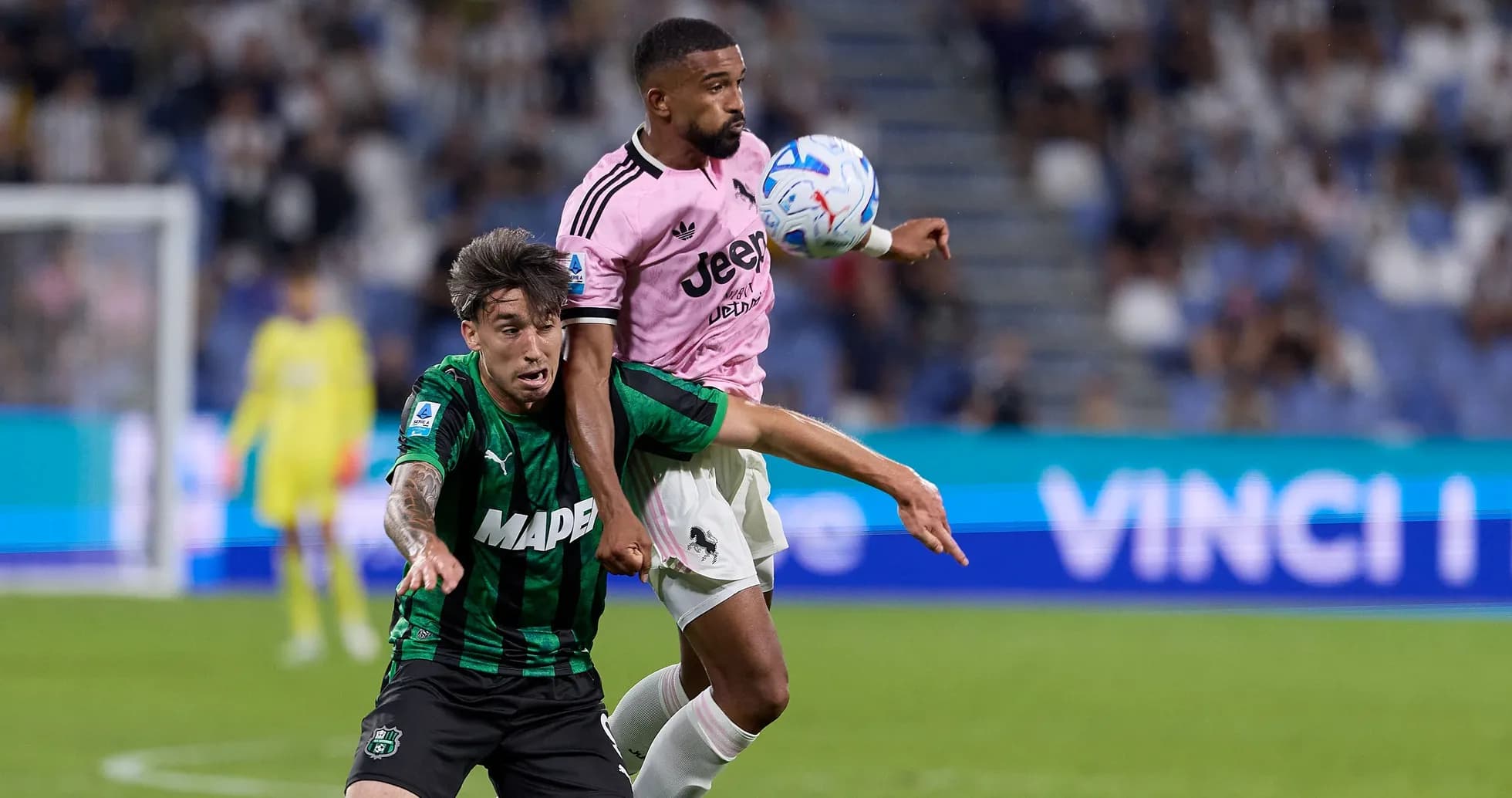 Two players contesting for the ball during match