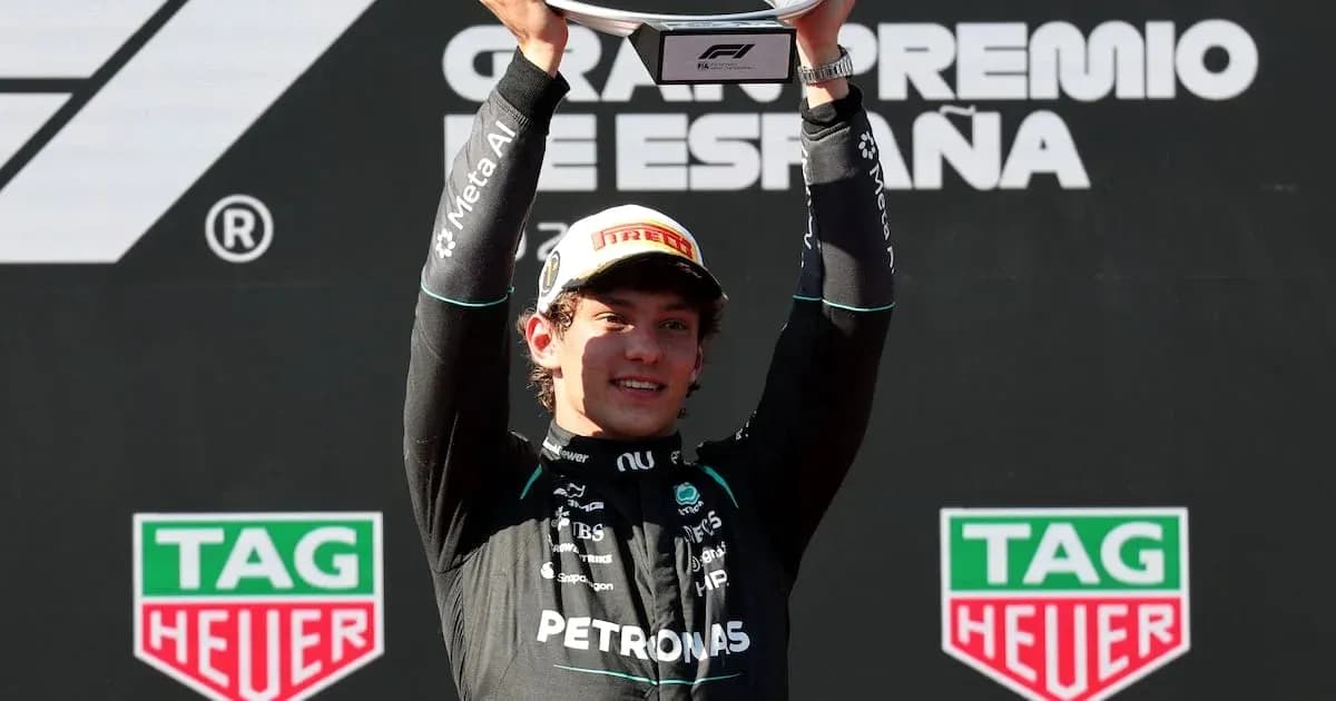Driver celebrating victory with trophy at podium
