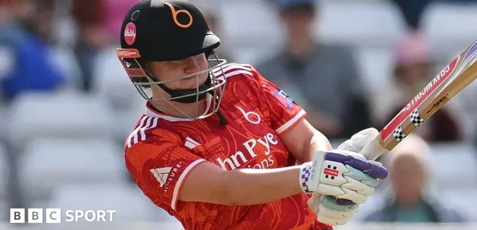 Batter striking the ball during cricket match