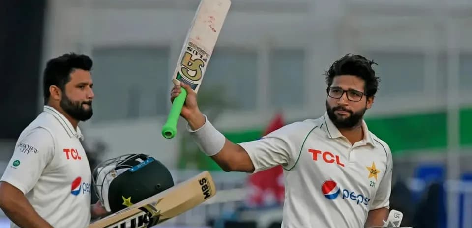 Two cricket players celebrating after a match