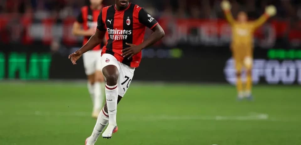 AC Milan player dribbling the ball on the pitch