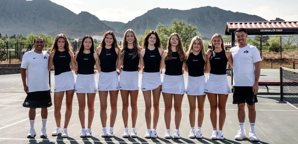 Tennis team posing together on court with coaches
