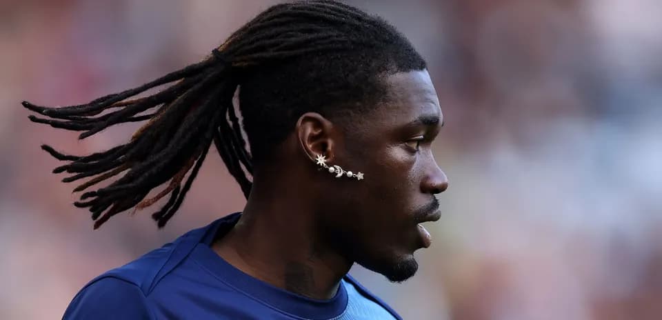 Player with dreadlocks and unique ear jewelry