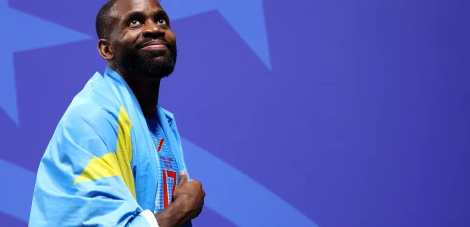Athlete wearing a blue flag and smiling