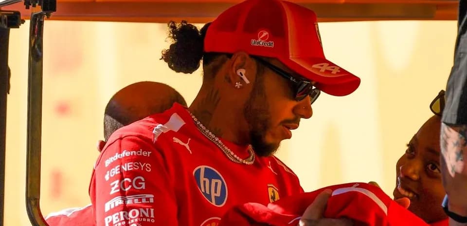 Driver in red uniform interacting with fans