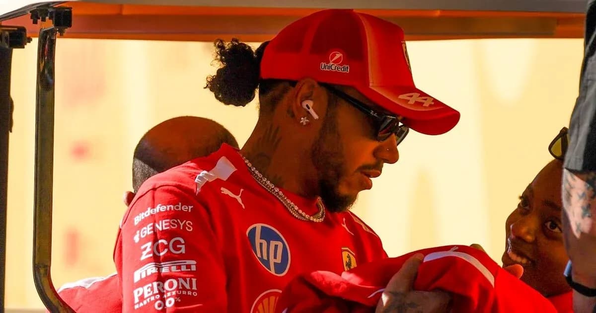 Driver in red uniform interacting with fans