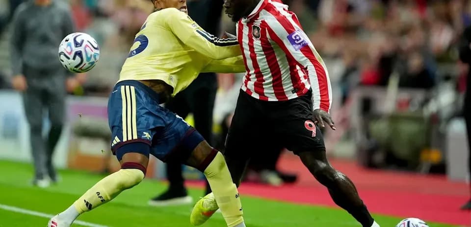 Players competing for the ball during football match