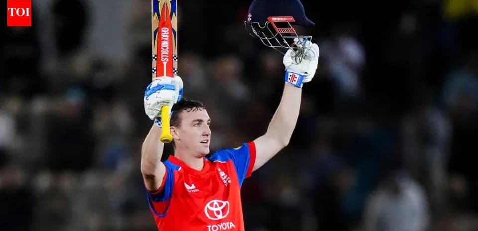 Batsman celebrating with raised bat and helmet
