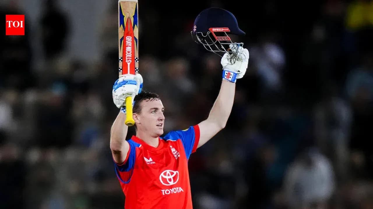Batsman celebrating with raised bat and helmet