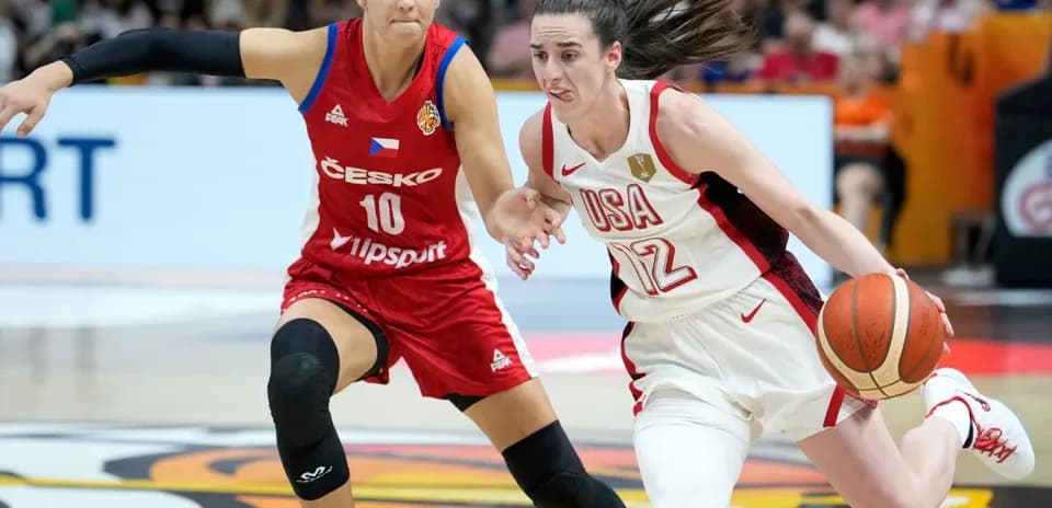 Player from USA dribbling past opponent during game