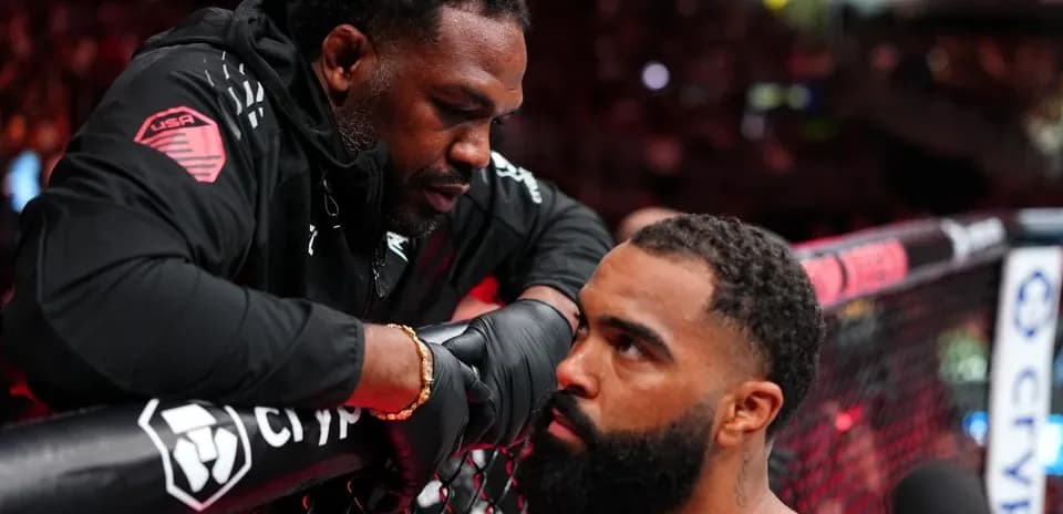Coach advising fighter during MMA match preparation