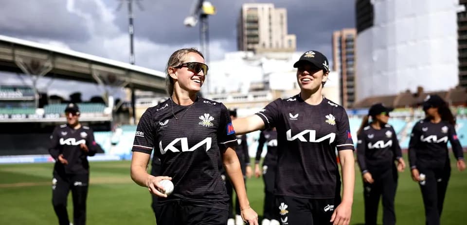 Two cricketers walking off the field after match