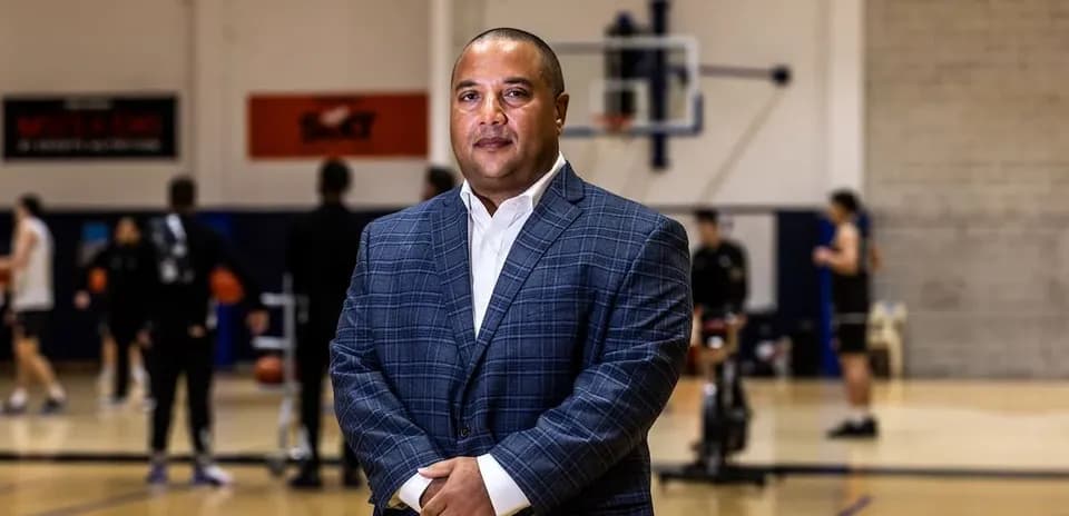 Coach standing on basketball court during practice