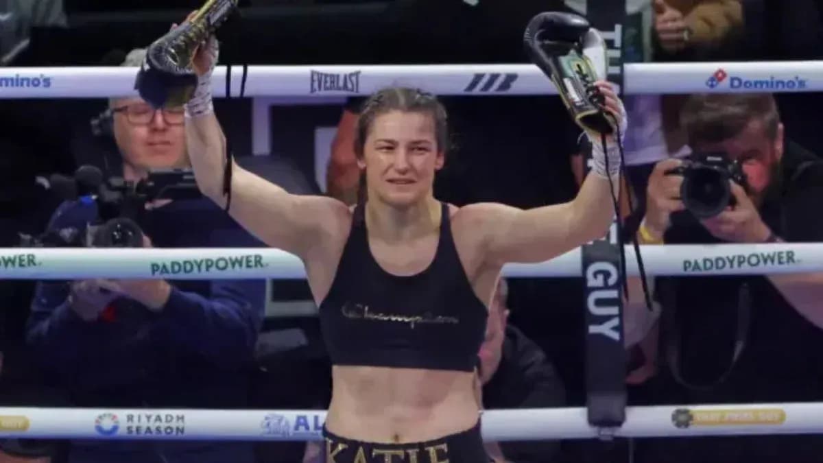 Katie Taylor celebrating victory with gloves raised