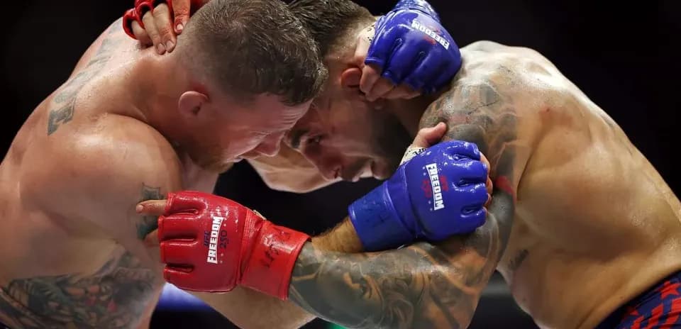 Two fighters in a clinch during a match