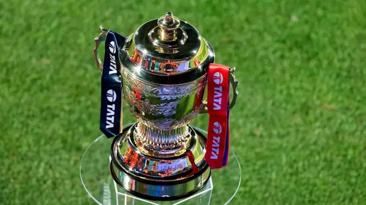 Trophy displayed on glass stand with ribbons