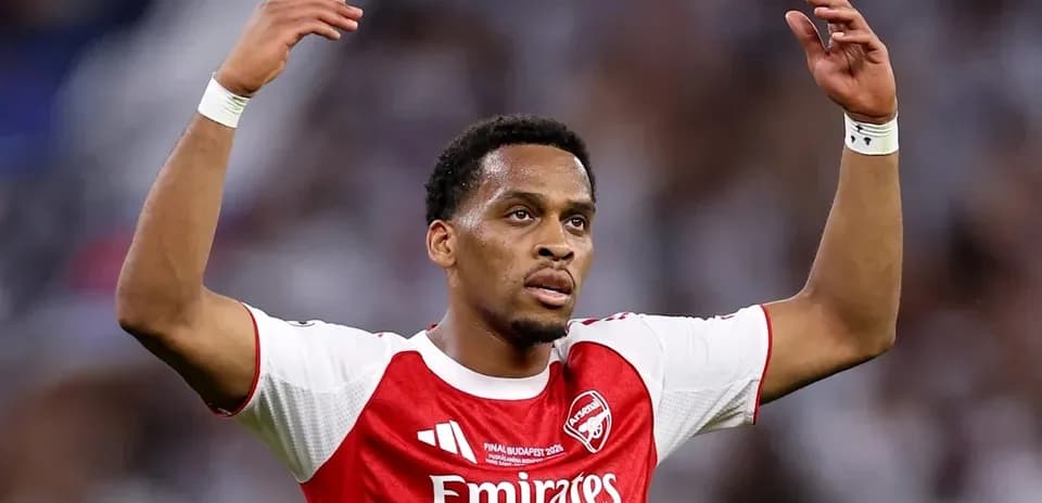 Player gesturing during match wearing Arsenal jersey