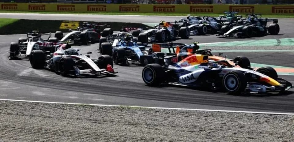 F1 cars racing through a corner on track