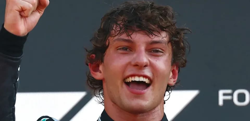 Racer celebrating victory with raised fist and smile