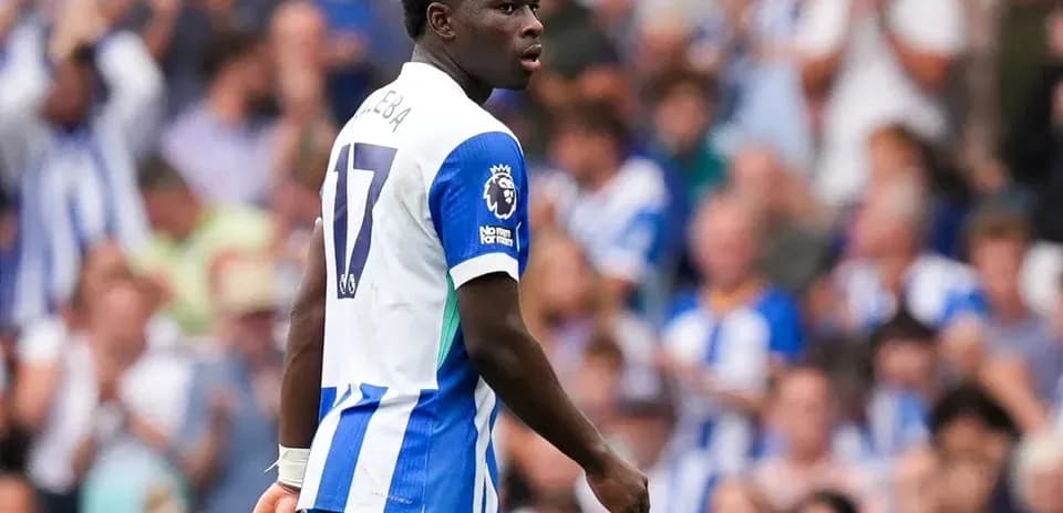 Player in blue and white kit on field during match