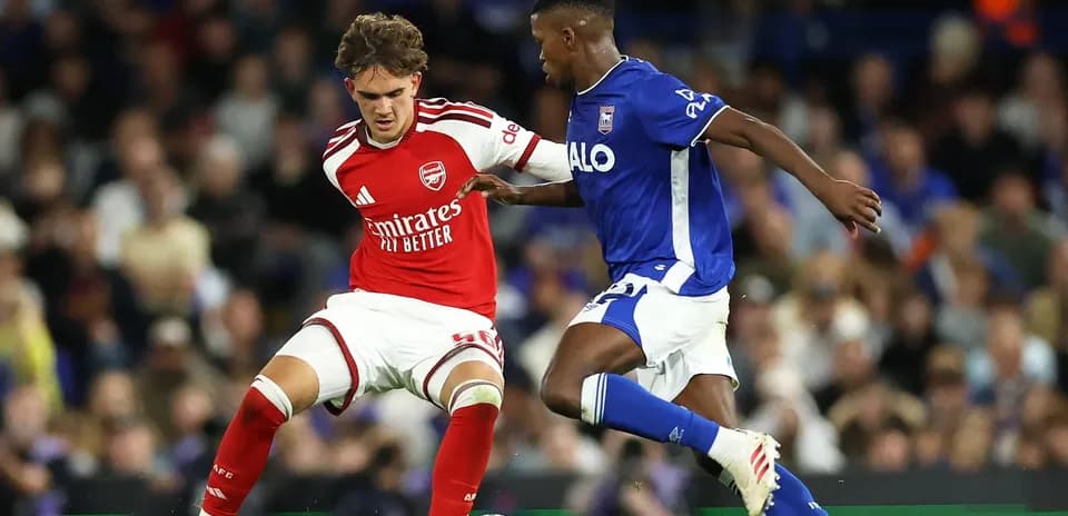 Player in red and player in blue contesting the ball