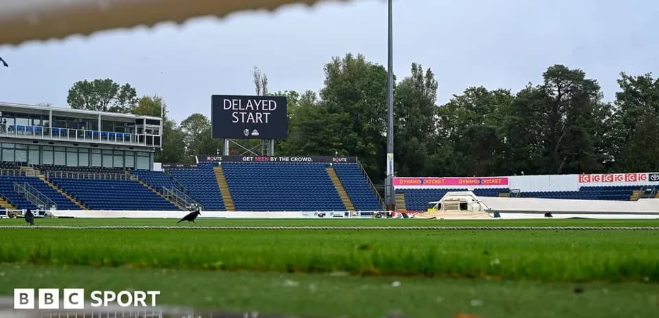 Cricket ground with delayed start sign and empty stands