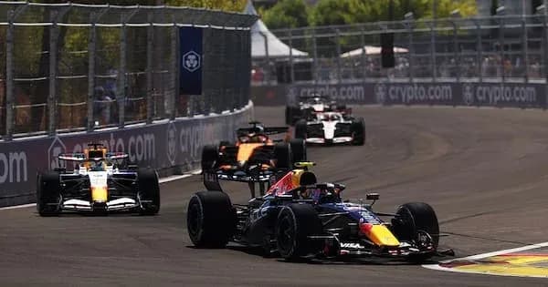 Four Formula 1 cars racing on a circuit