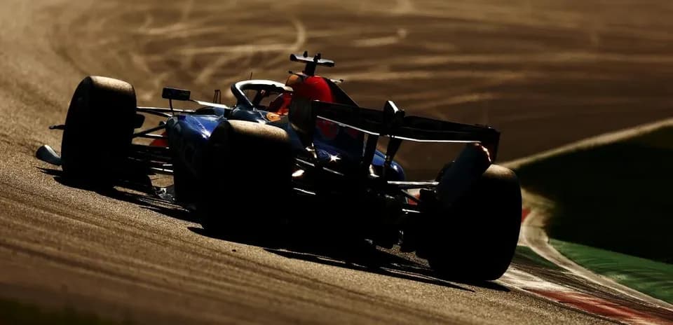 Formula 1 car navigating a curve on track