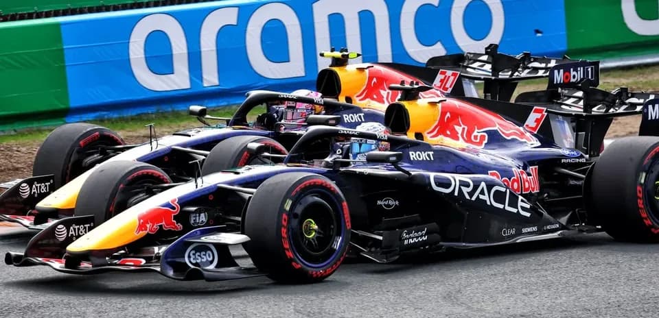 Two Red Bull Racing cars racing on track