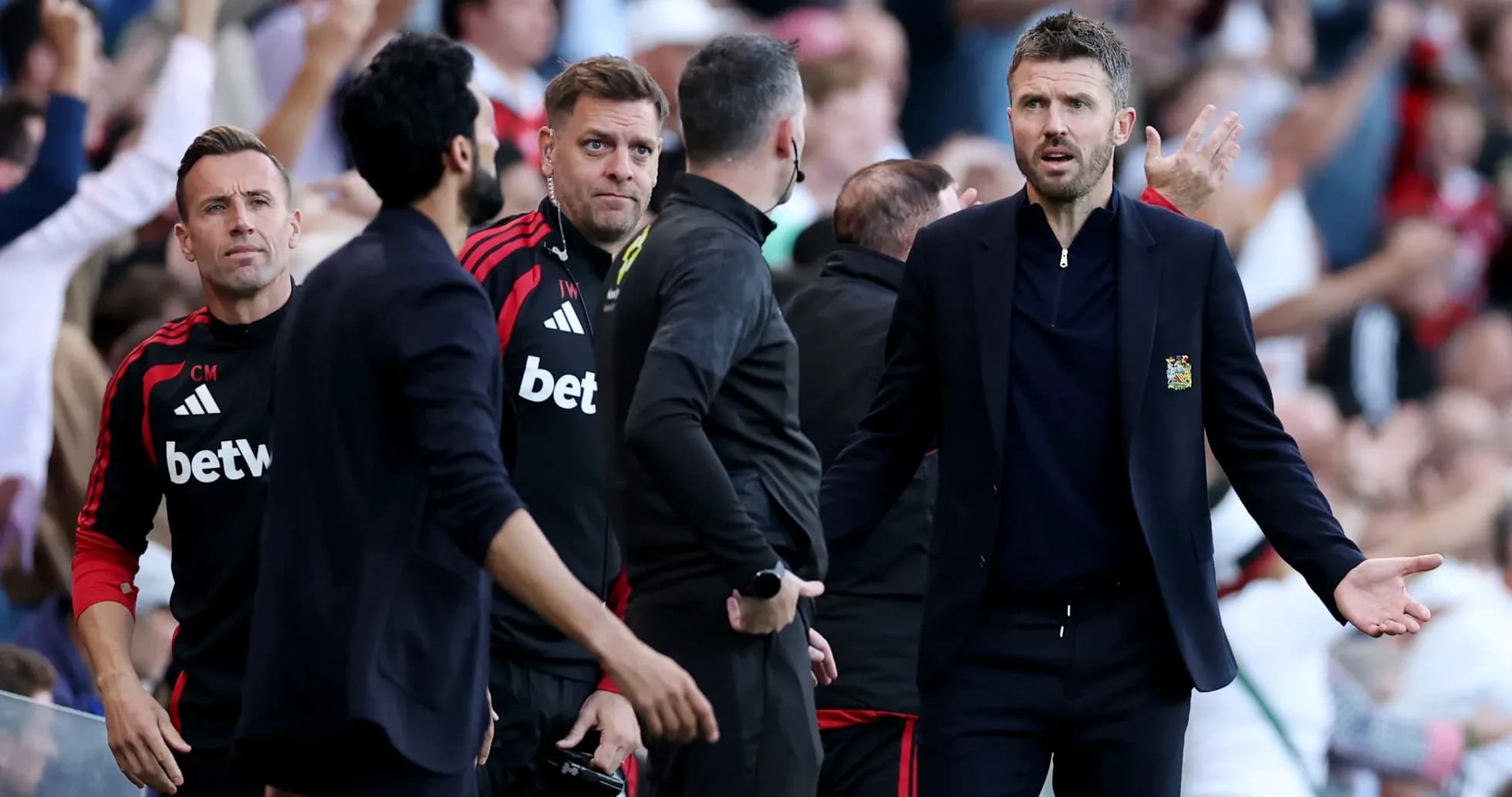 Coaching staff reacting during a match on the sideline