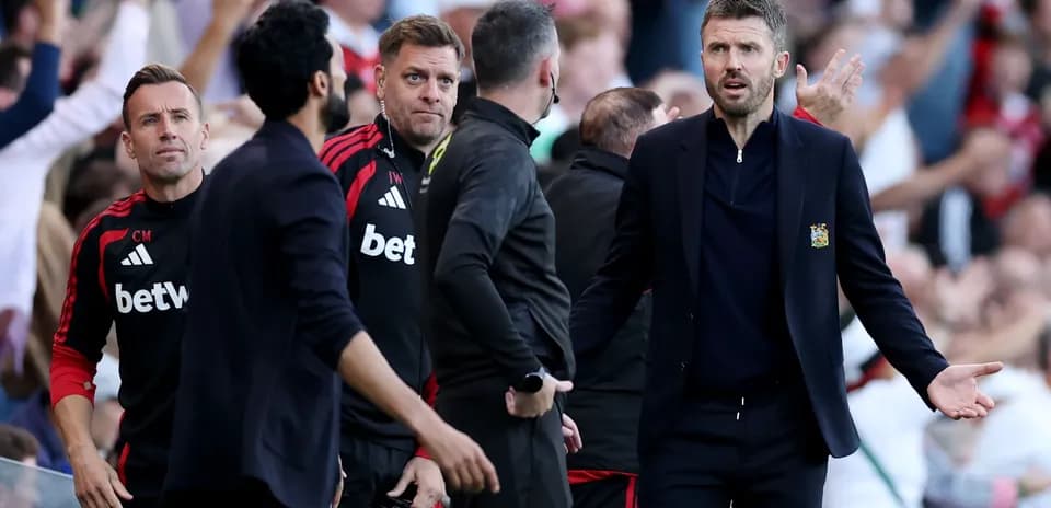 Coaching staff reacting during a match on the sideline