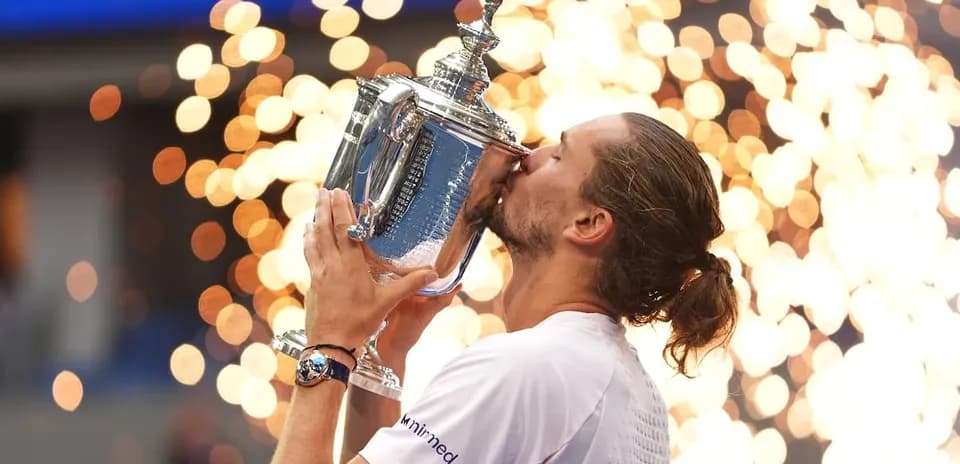 Player celebrating by kissing trophy with sparks in background