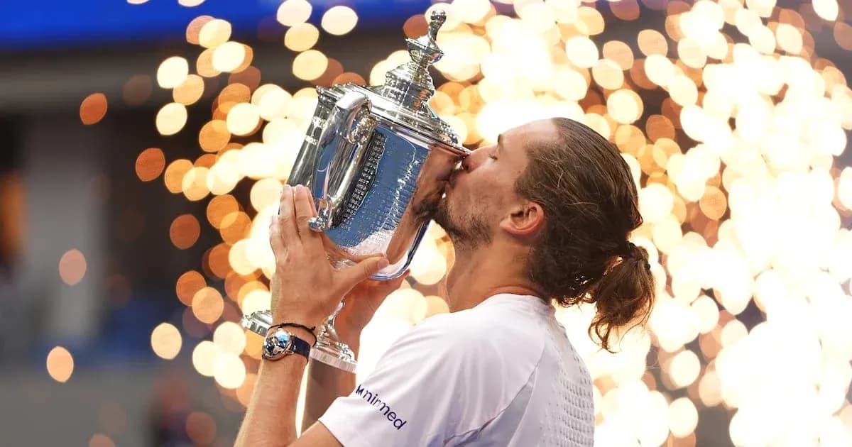 Player celebrating by kissing trophy with sparks in background