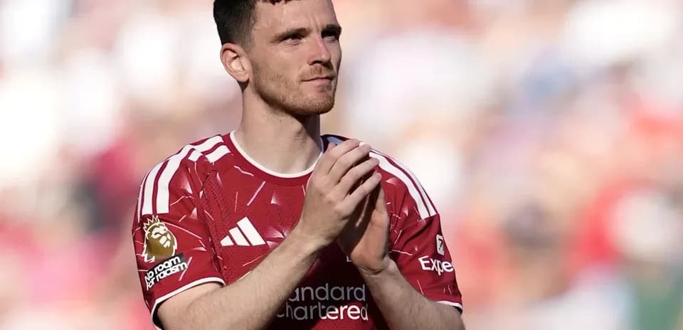 Player applauding fans wearing red team jersey