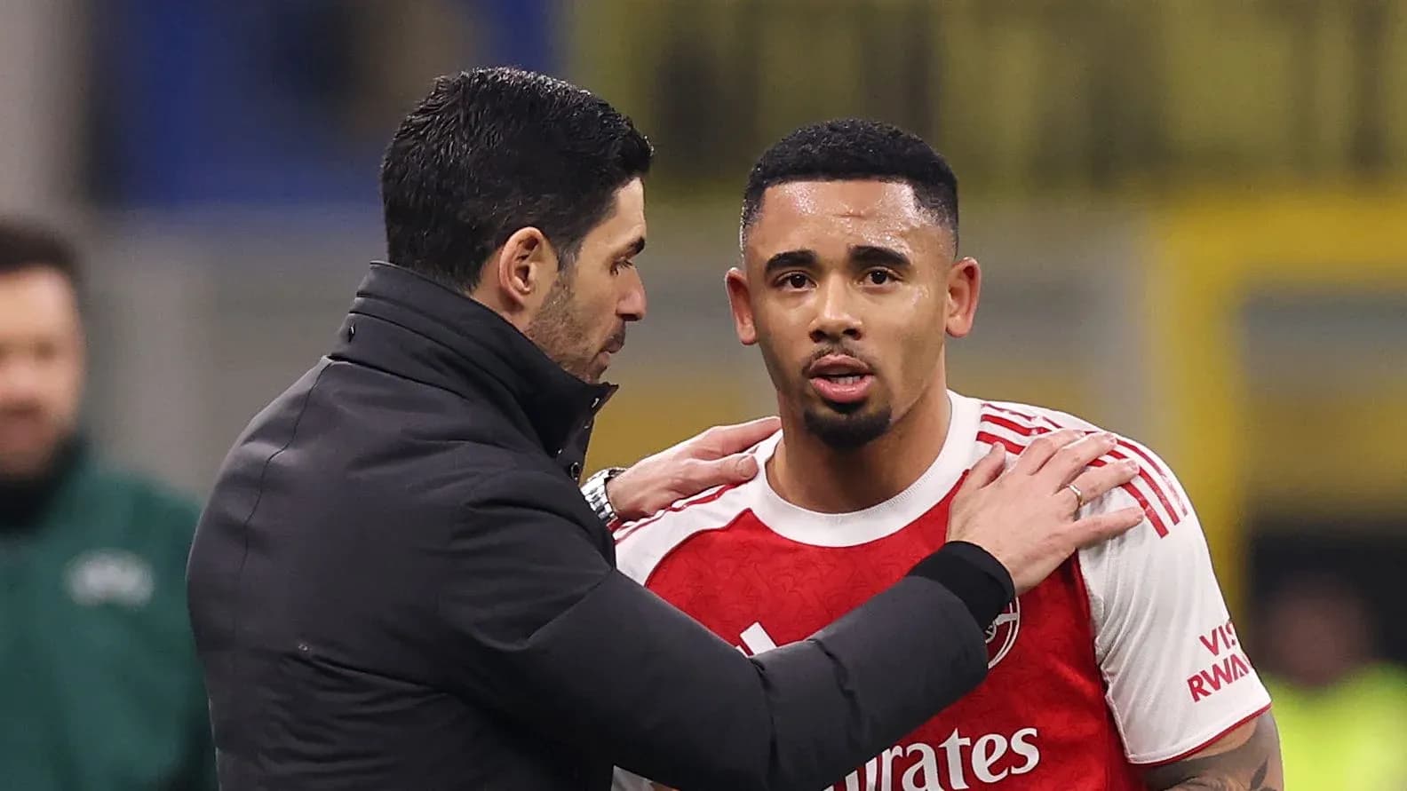 Coach discussing with player during match substitution
