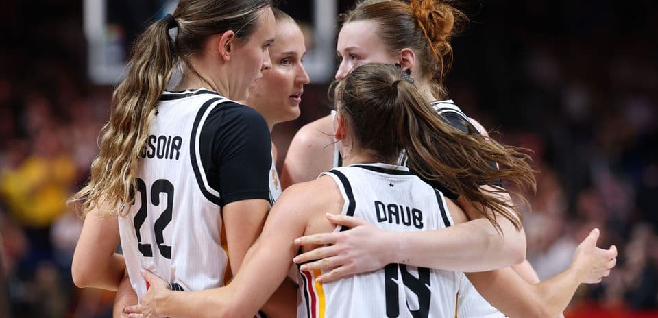 Players huddled together during a basketball game