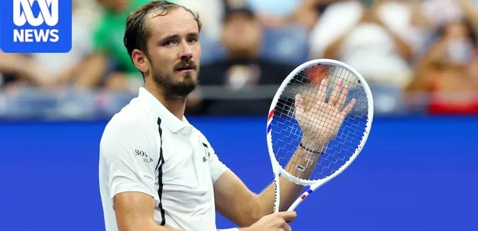 Tennis player waving while holding racket on court