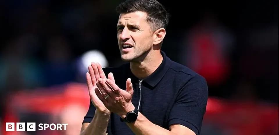 Coach gesturing and applauding during match