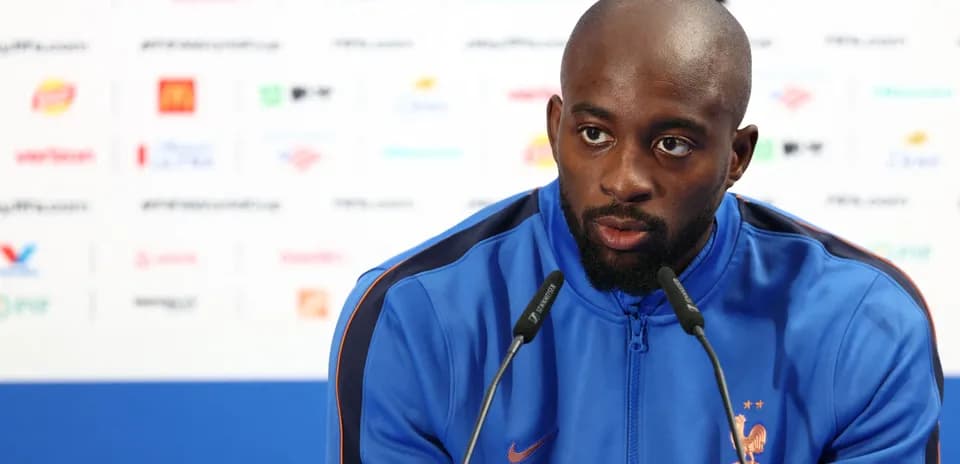 Player speaking at pre-match press conference podium