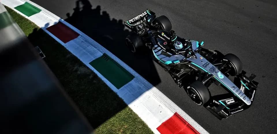 Formula 1 car navigating a track corner