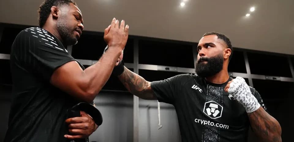 Two fighters exchanging high-fives in locker room