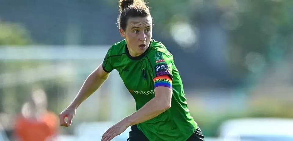 Player in green jersey running on the field