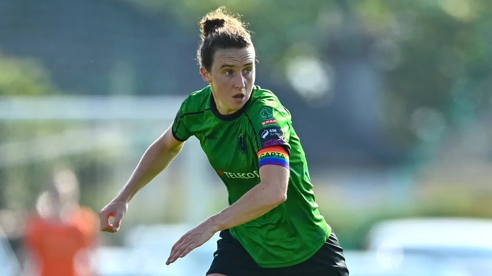 Player in green jersey running on the field