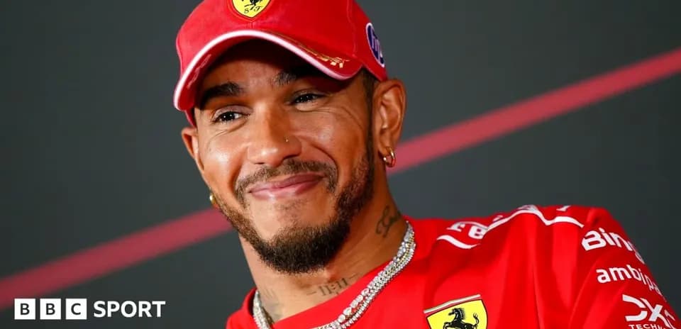 Driver wearing Ferrari cap during press conference