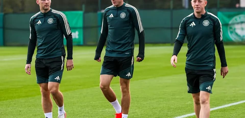 Three players walking on training pitch