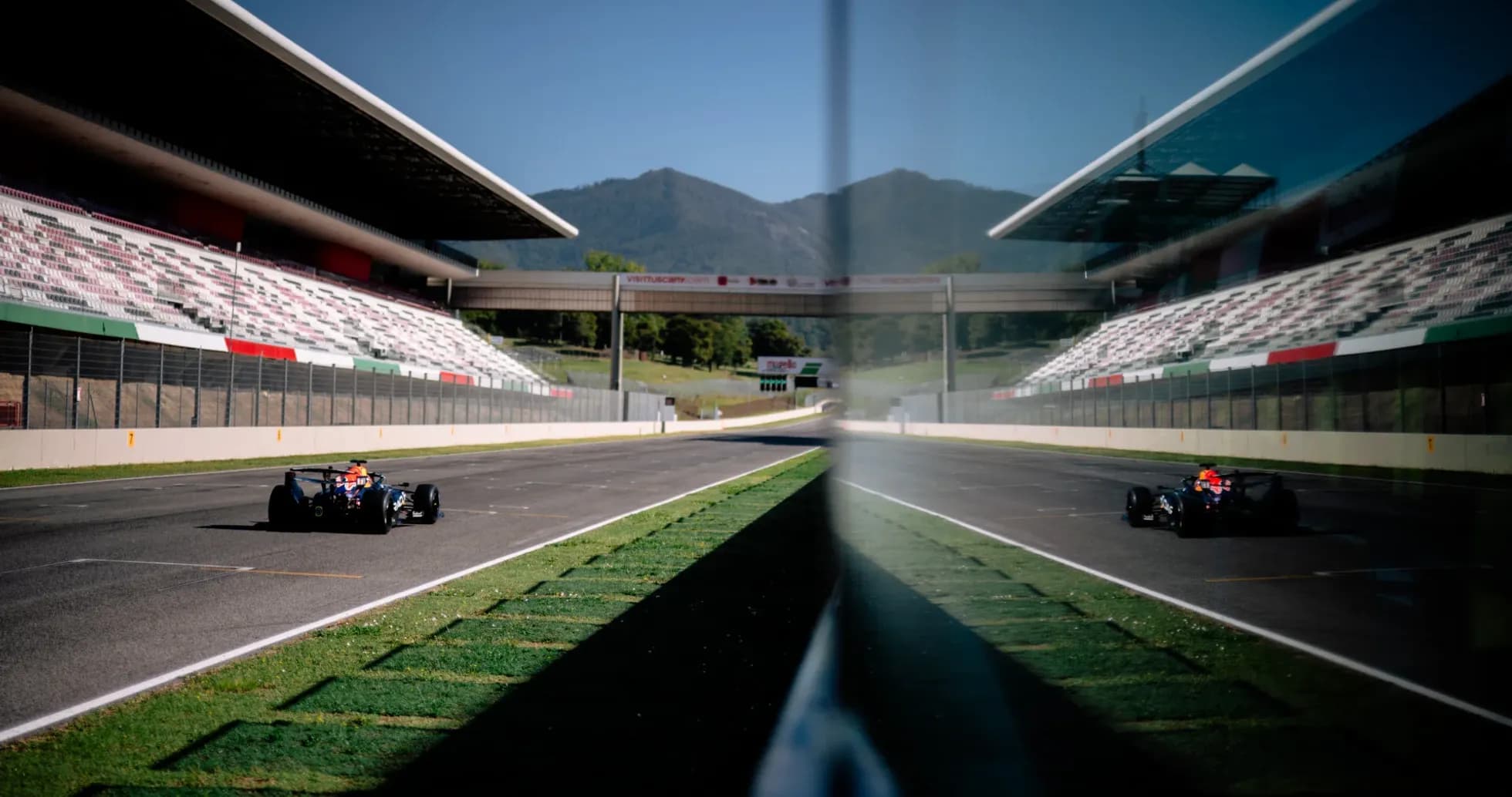 Race car on track with grandstands in background