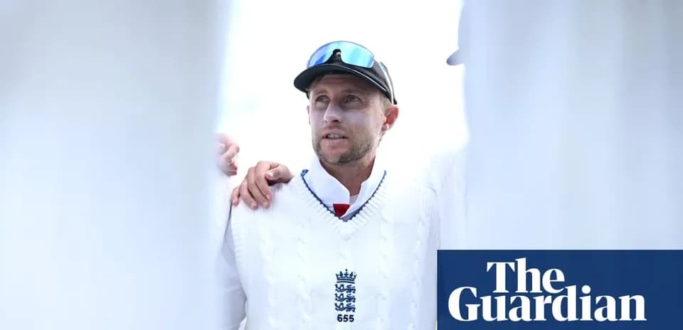 Cricketer wearing white sweater during team huddle