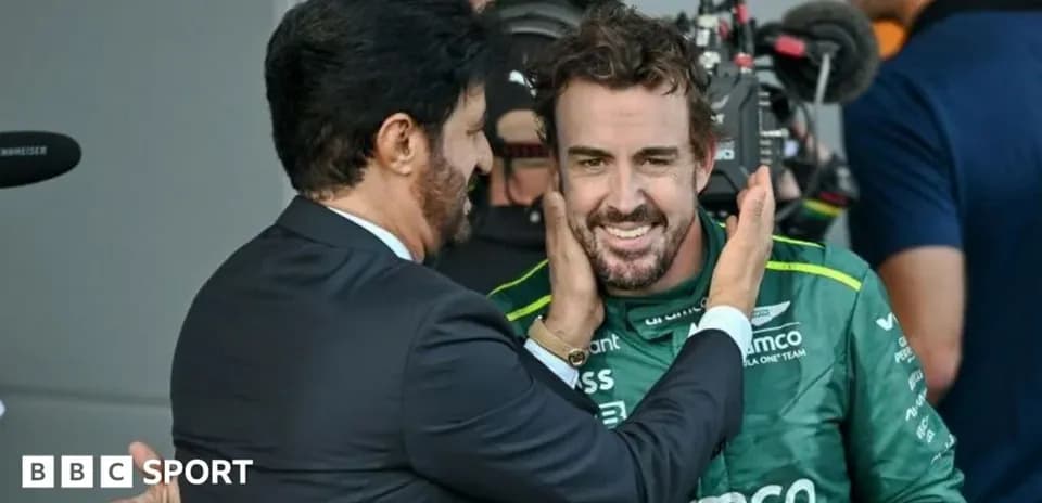 Two men interacting in a motorsport environment